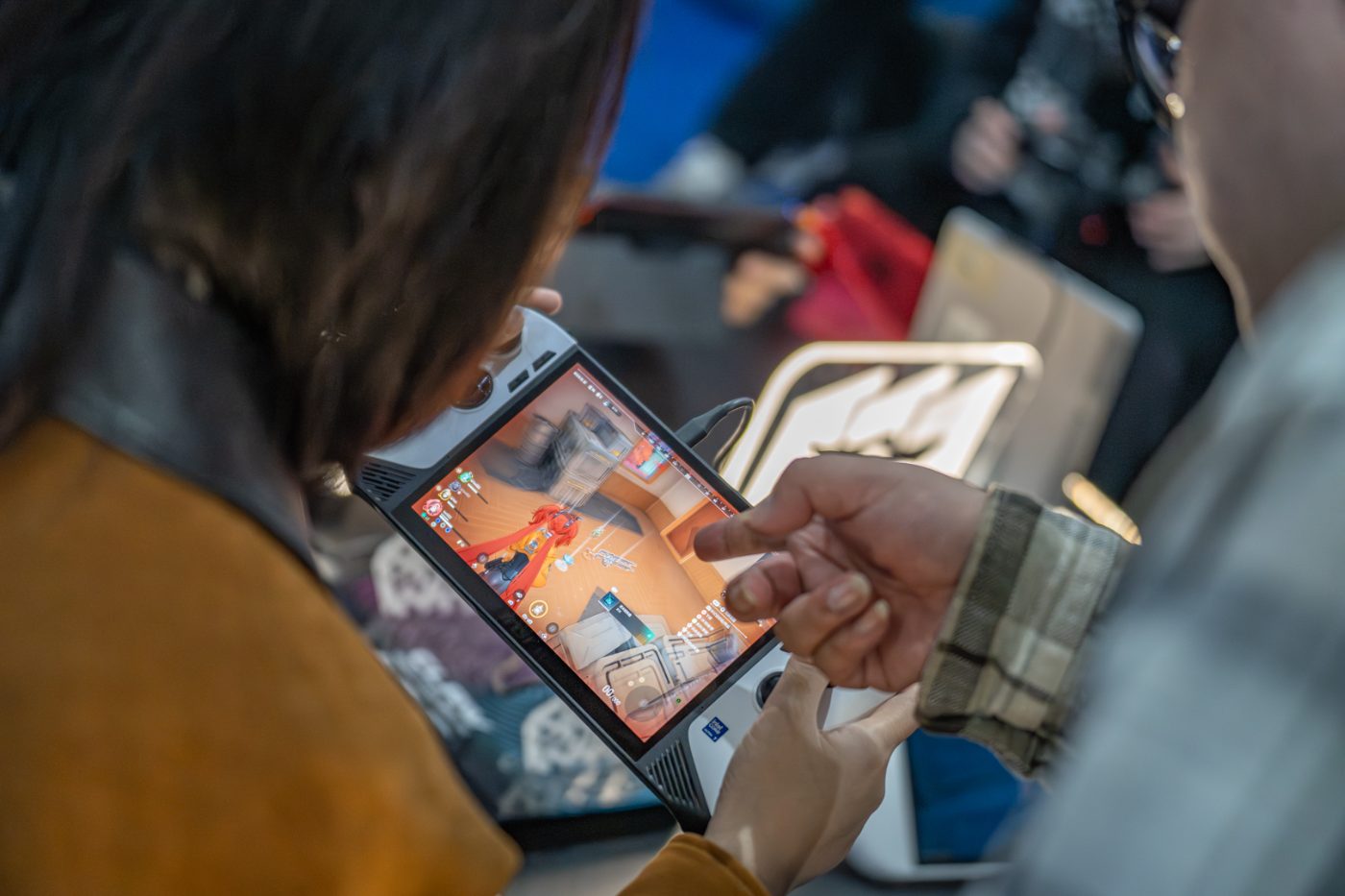 Attendee playing a match on an MSI handheld at IEM